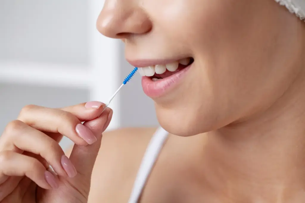 Interdental brush cleaning around an implant site to help you heal faster after dental implants.