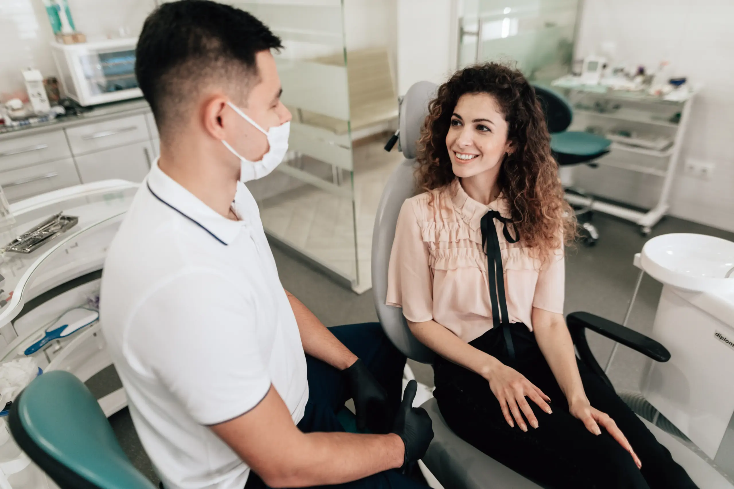 Patient and dentist discussing how to heal faster after dental implants during a calm consultation.
