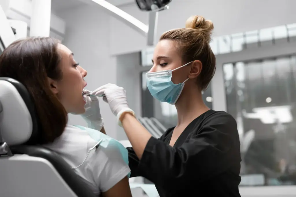 Dental professional examining a patient during an emergency dental appointment to identify the cause of tooth pain.