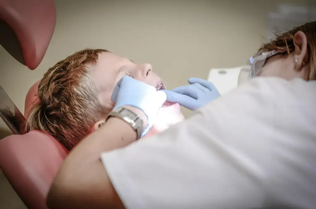 Dentist carrying out an urgent dental assessment after a child tooth injury.