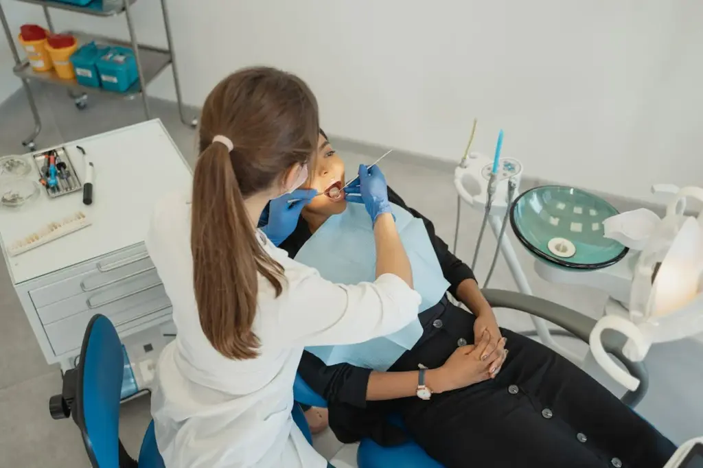 Dentist examining a patient during treatment for a cracked tooth.