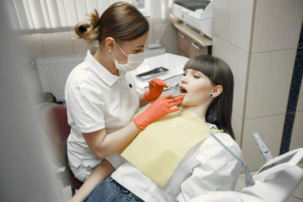 Dentist examining patient before porcelain veneers treatment.