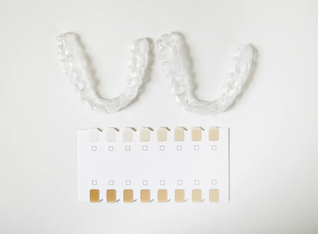 Custom trays and shade guide for dentist-supervised home teeth whitening.
