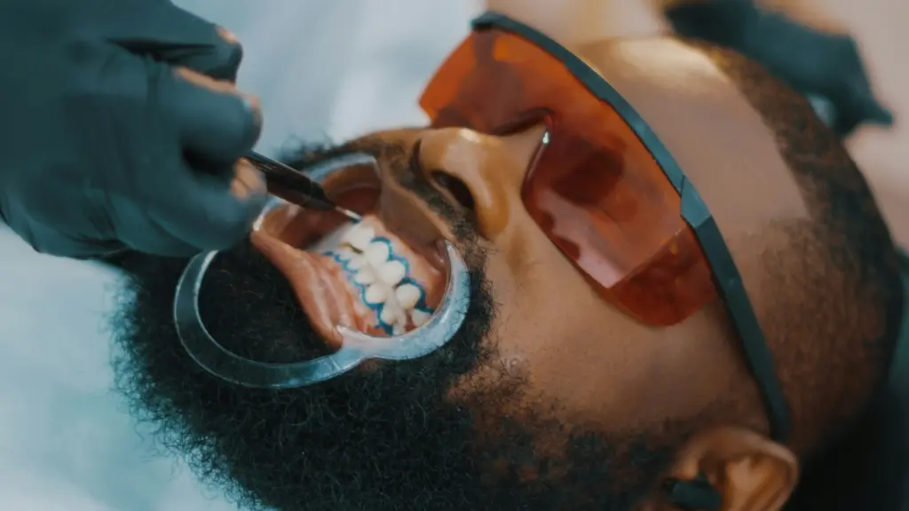 Dental professional preparing a patient for in-practice teeth whitening.