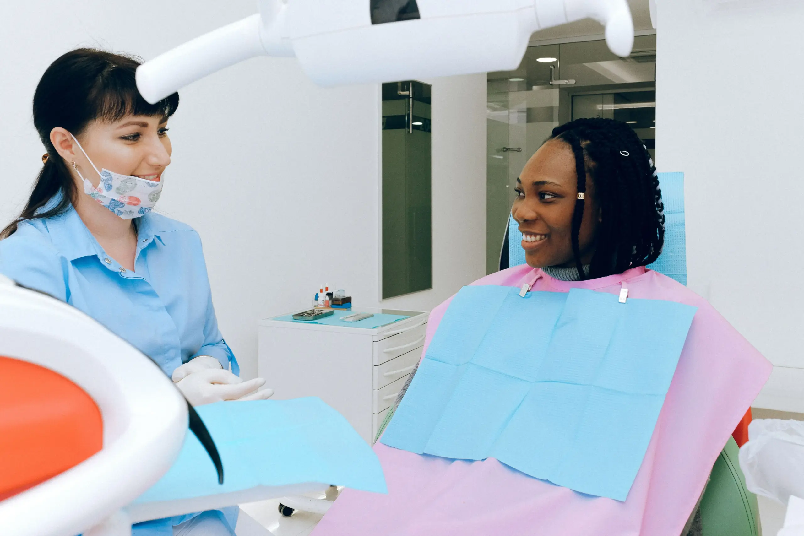Dentist discussing cosmetic dental treatment with a patient.