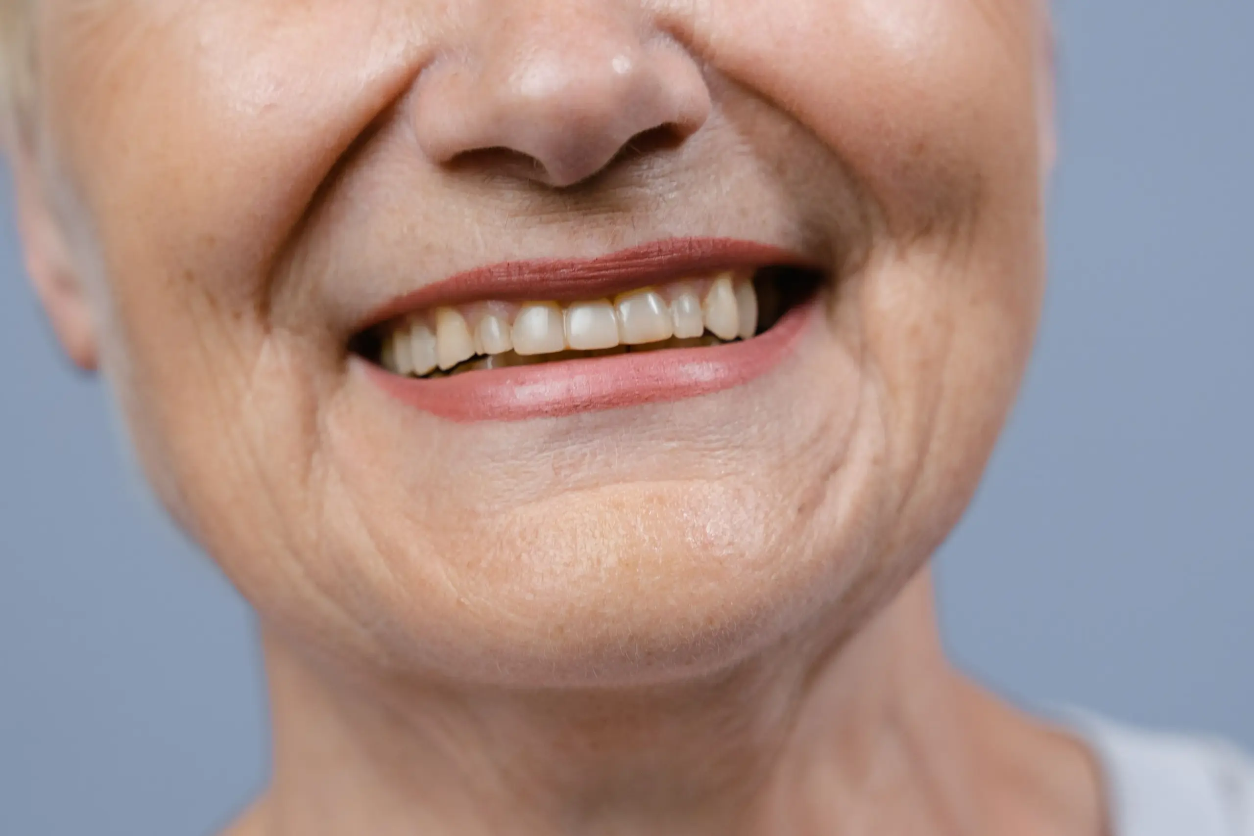 Close-up of an adult smiling with natural teeth.